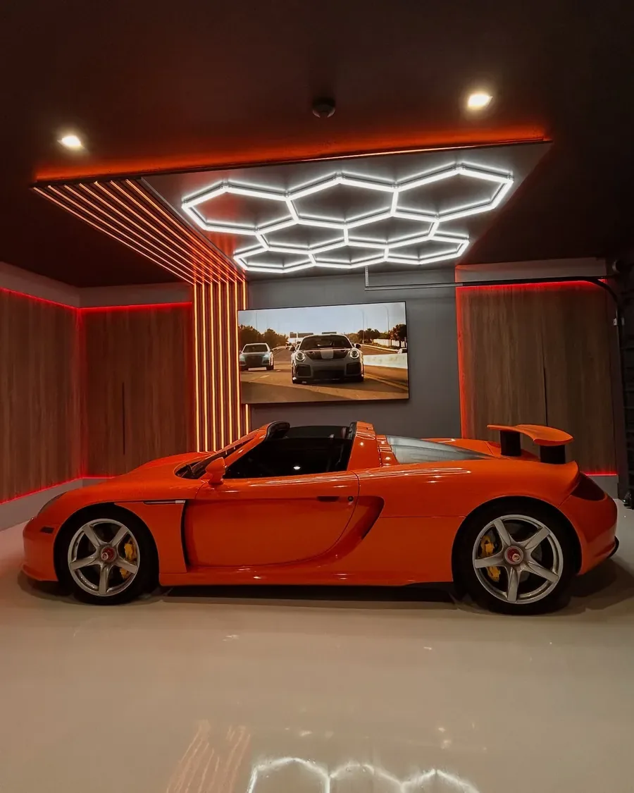 His Porsche Carrera GT under the garage lights