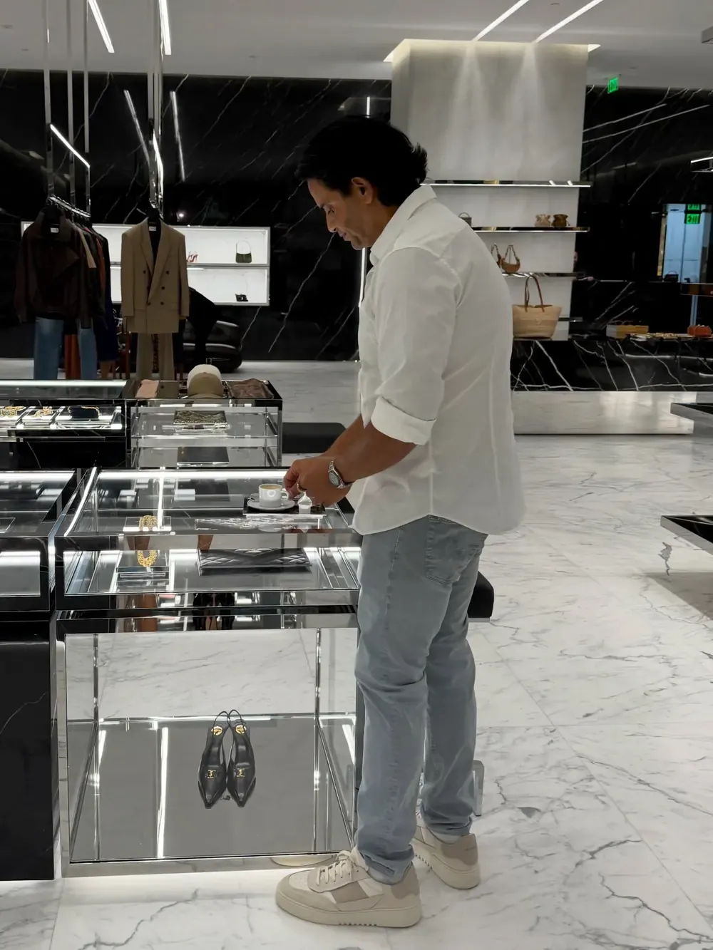 Kamran Farid looking over a display case