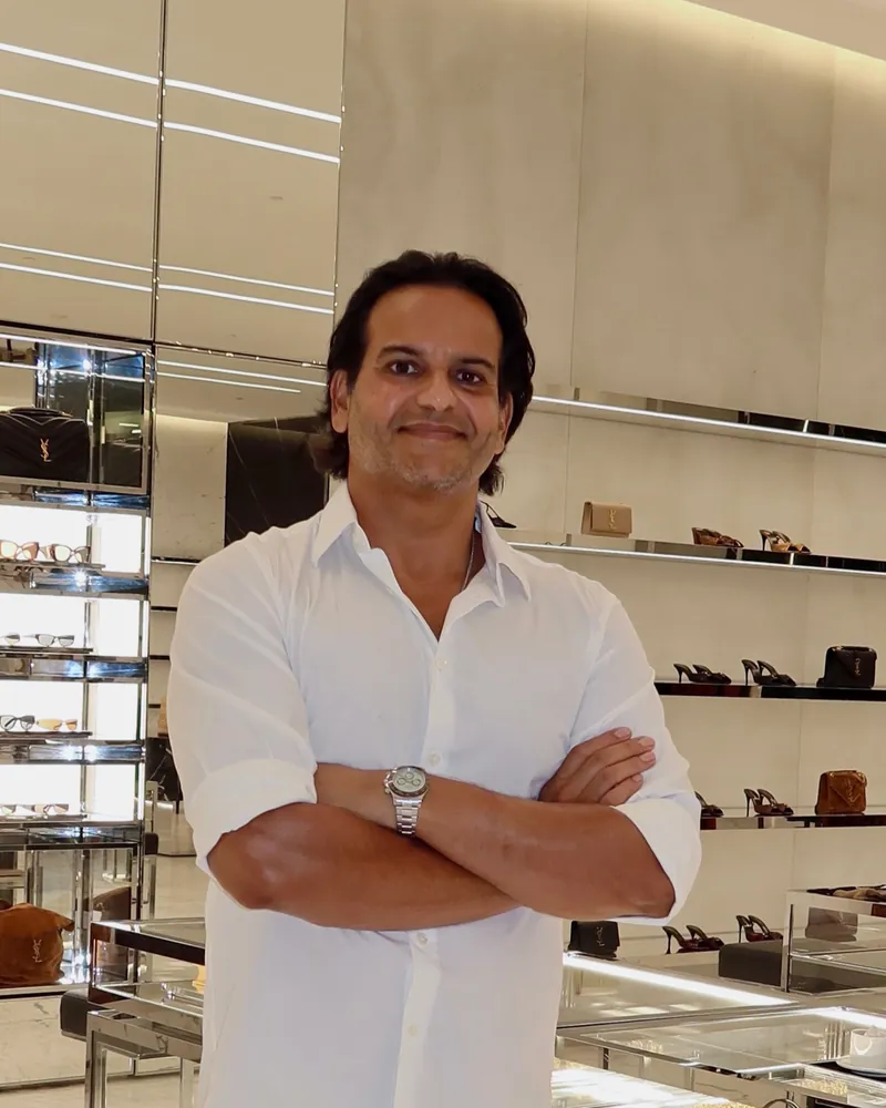 Kamran Farid, smiling, arms crossed