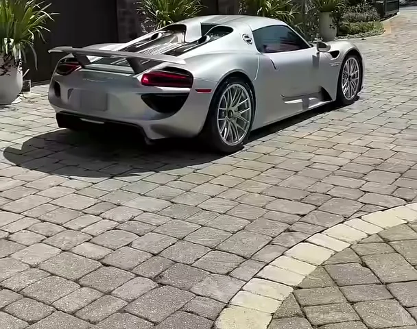 His Porsche 918 Spyder in the driveway